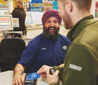 Tesco cashier checking out a customer